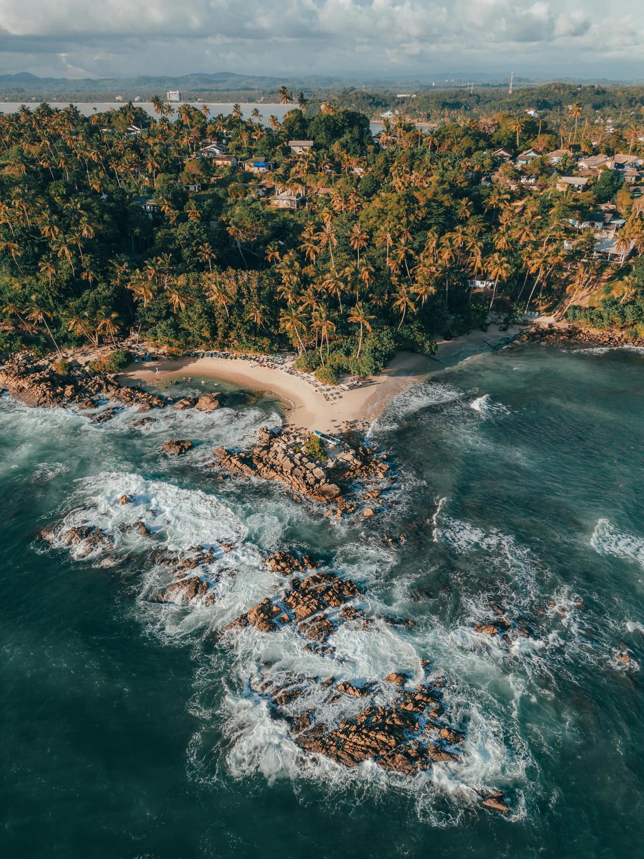 The crescent bay at Mirissa on Sri Lanka's southern coast, fringed with coconut palms