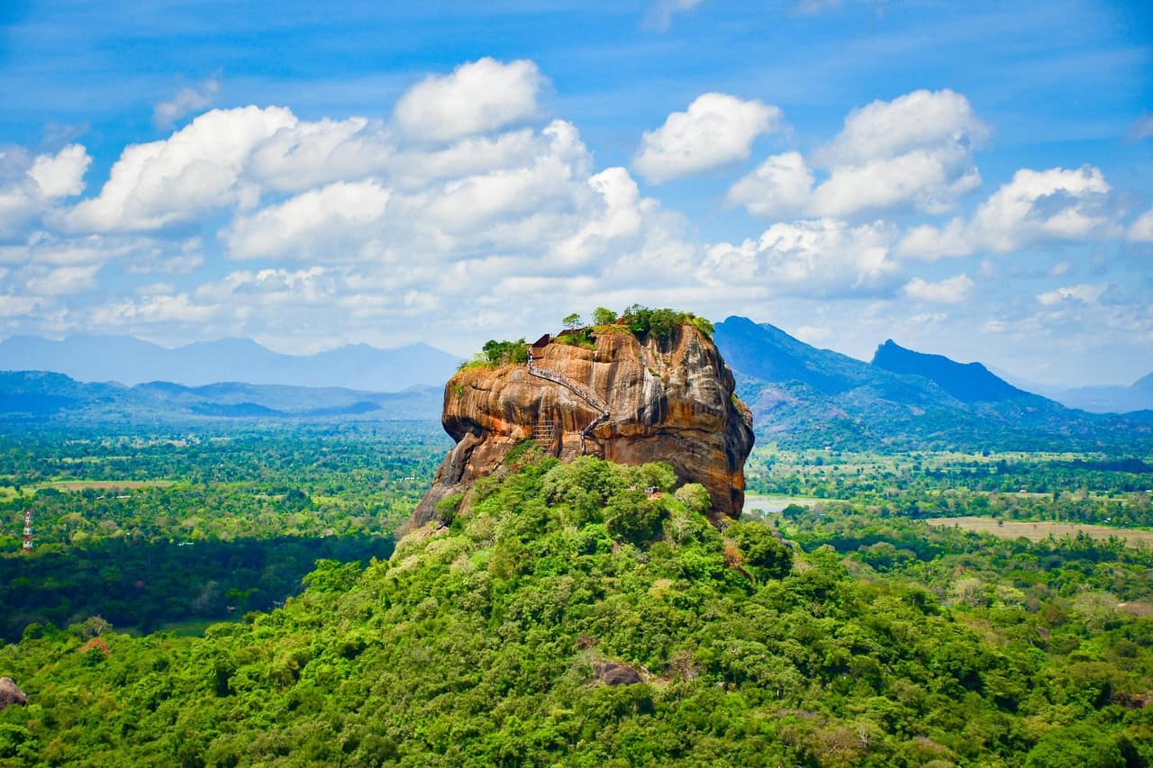 The sheer western face of Sigiriya rock fortress rising from the surrounding jungle plain in central Sri Lanka